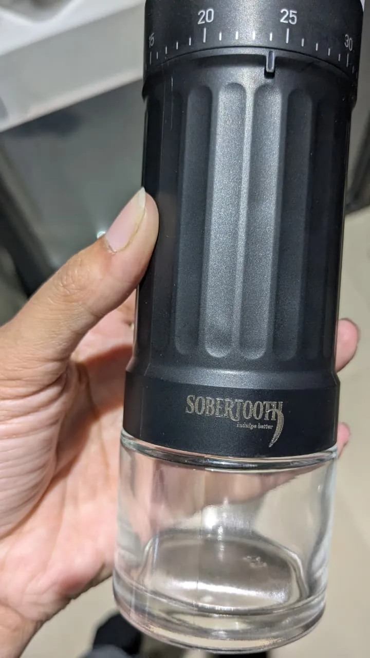 The Mastodon hand grinder held in one hand